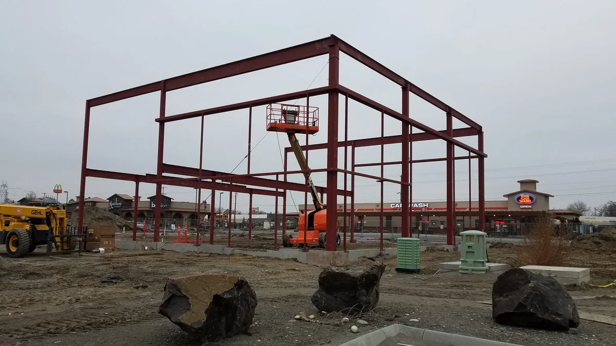 Side elevation of The Auto Lot with metal wall panels and paved lot
