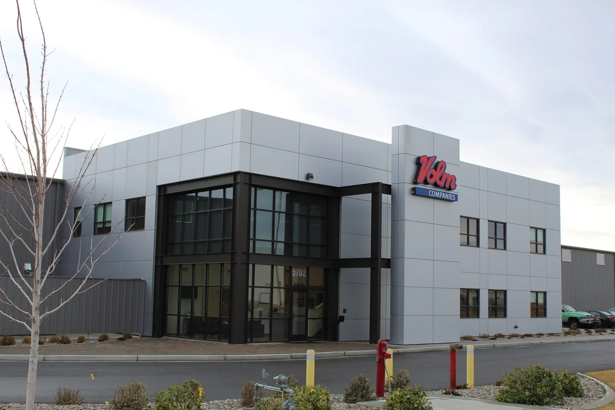 Corner entrance view with updated facade and storefront glazing at Volm Companies